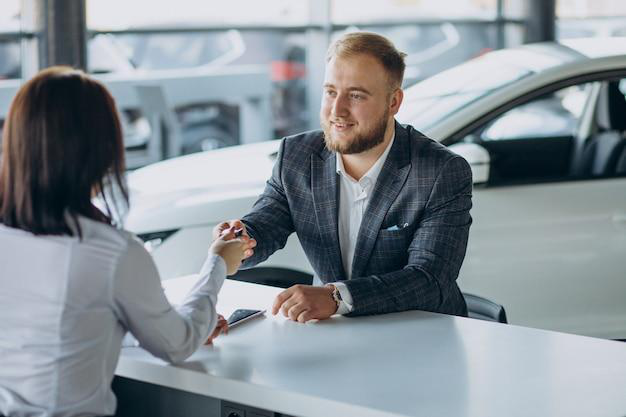 A person shaking hands with an auto tag agency team member