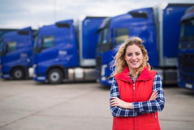 A fleet manager standing in front of a fleet of trucks