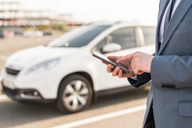 A person using a phone to complete automobile registration online