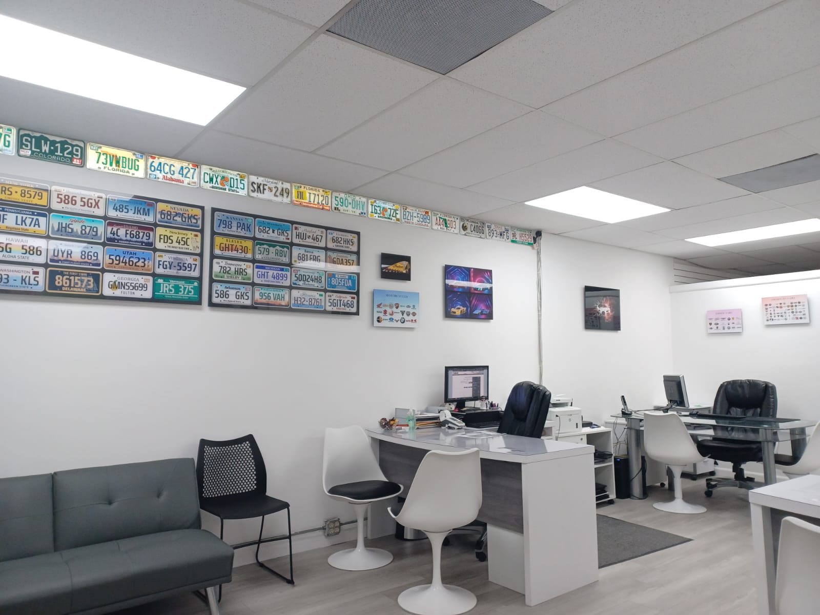 An auto agency office with specialty plates on a wall