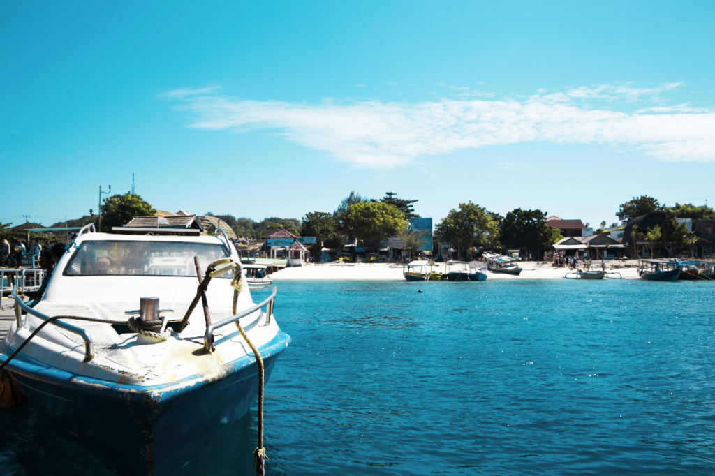 A boat tied to a dock surrounded by blue water