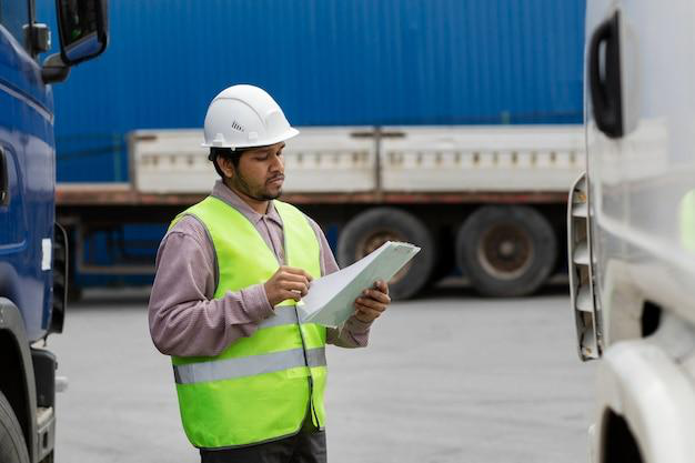 A fleet manager holding a clipboard