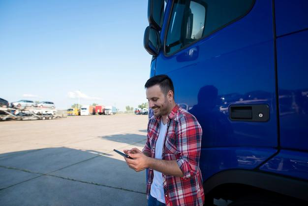 A fleet manager standing next to a large vehicle