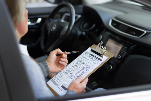 A person holding a car registration form