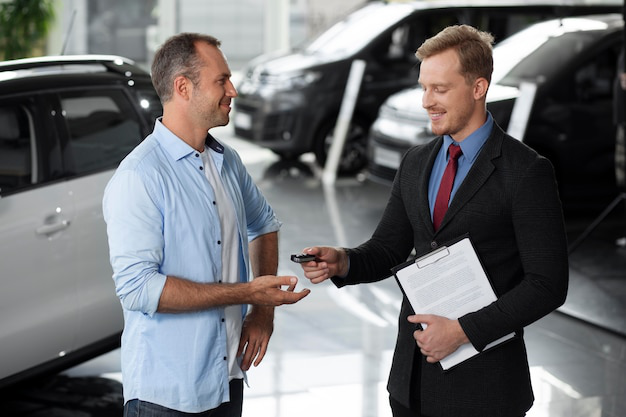 A person receiving car keys after a successful title transfer