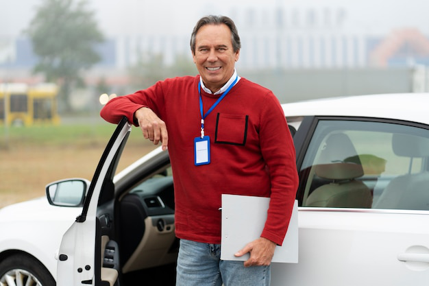 A person standing with their hand leaning against a car door