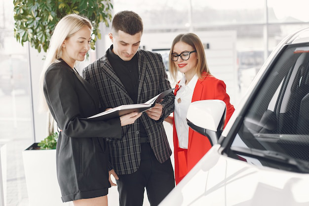 An auto tag agency professional and a client reading a document