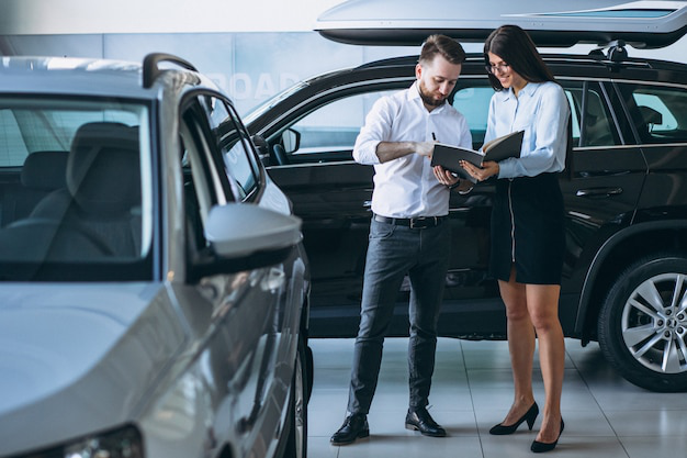 An auto tag agency professional helping a client understand vehicle title transfers