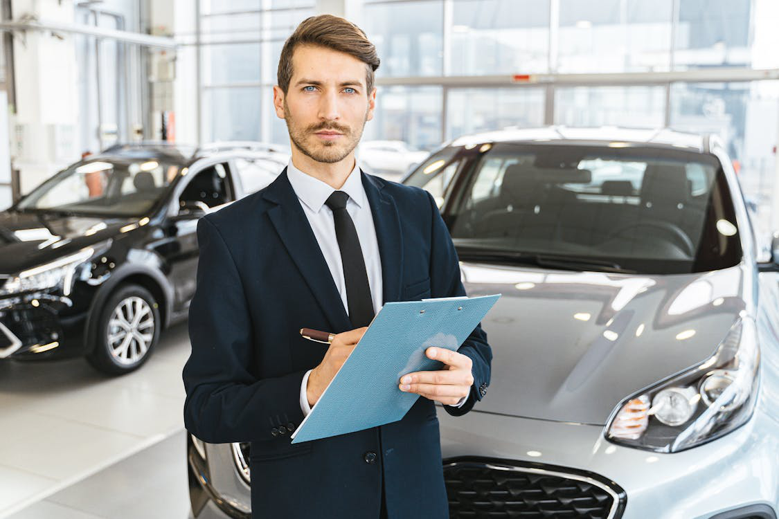 An auto tag agency professional holding a notepad