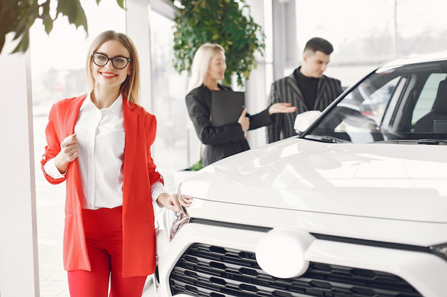 An auto tag agency professional standing next to a white car