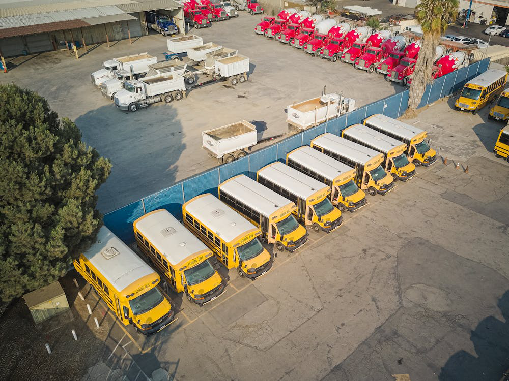 Bird's eye view of a parking lot with fleets of vehicles