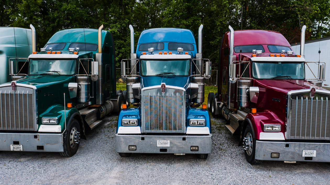 Trucks in different colors parked together