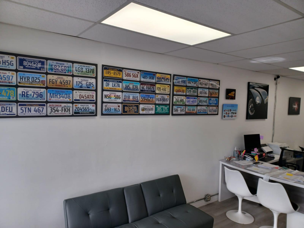 An auto tag agency office's wall lined with license plates