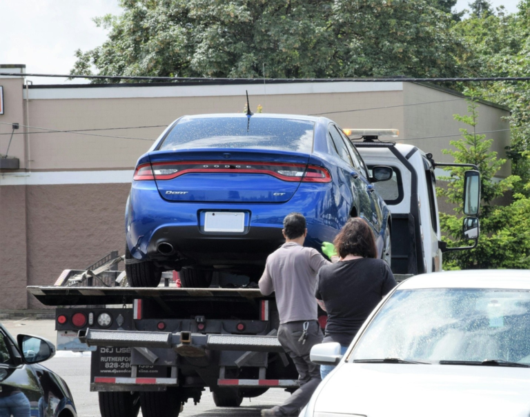 A car being loaded onto a tow truck