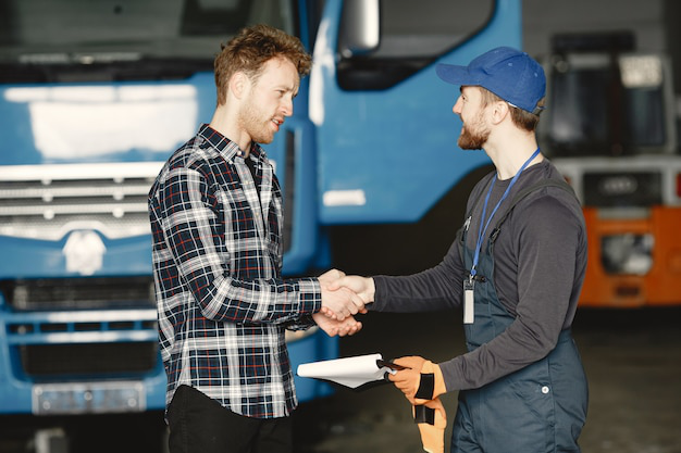 A fleet manager shaking hands with a title transfer expert