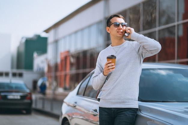 A person drinking coffee while talking on the phone