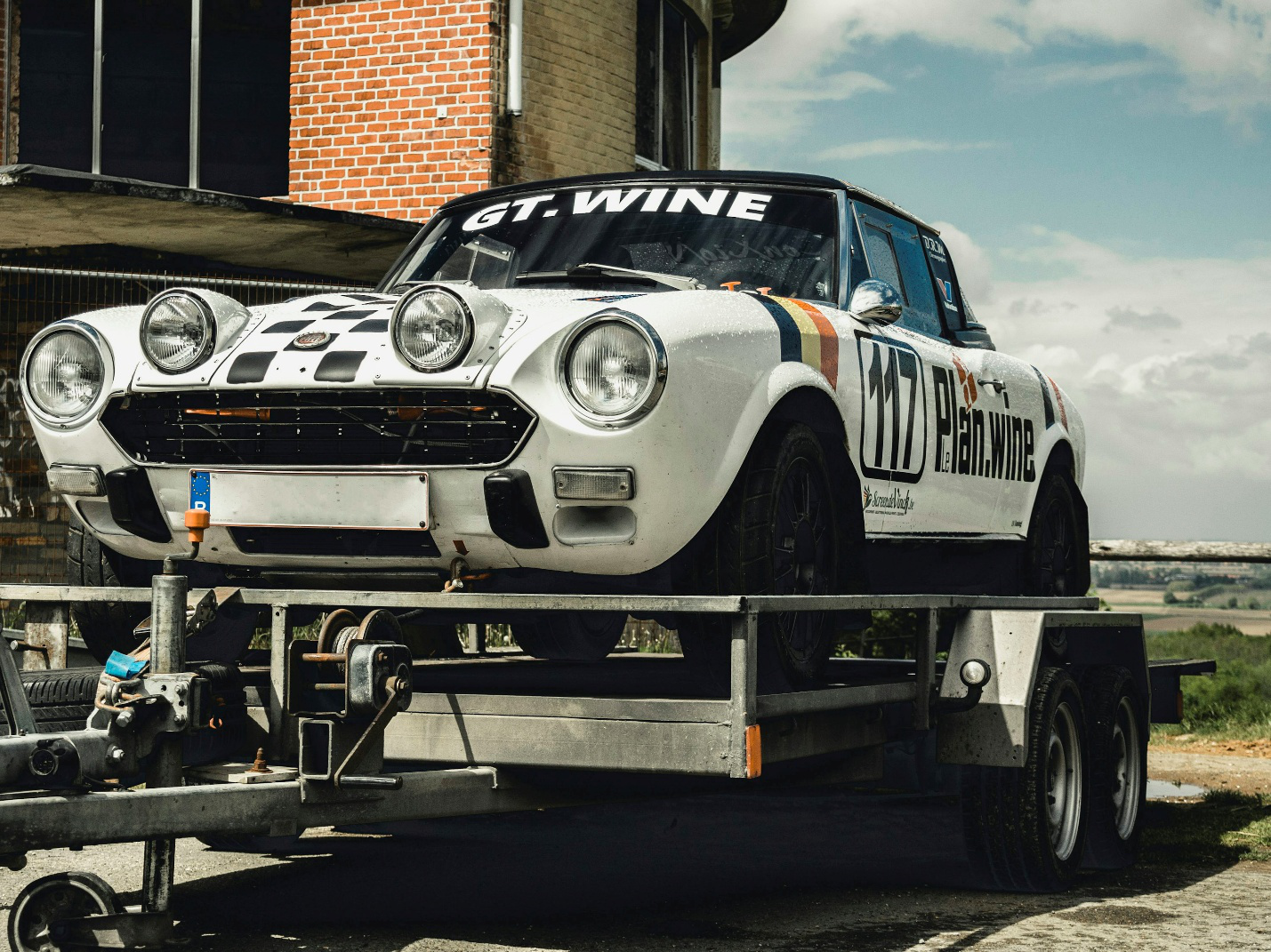 A vintage car on a tow truck