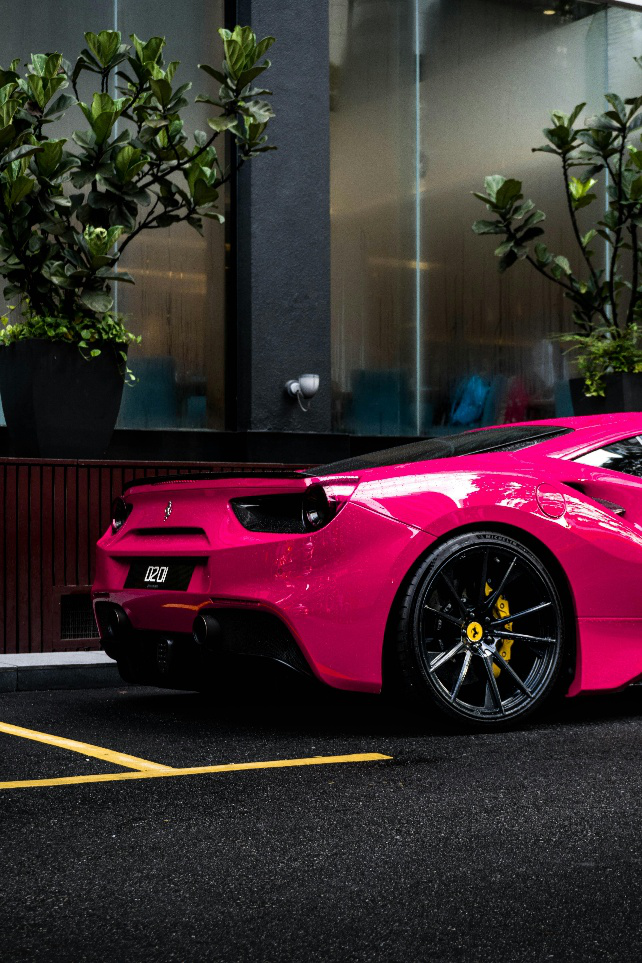 A picture of a modern pink car