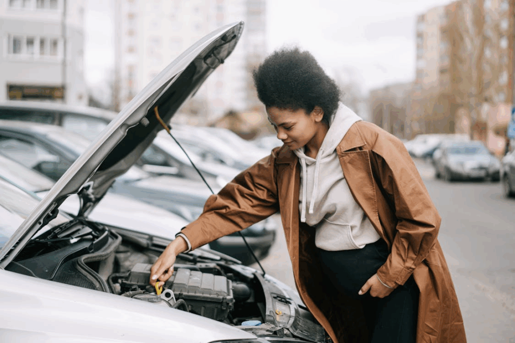 Expectant mother fixing her car on the roadside
