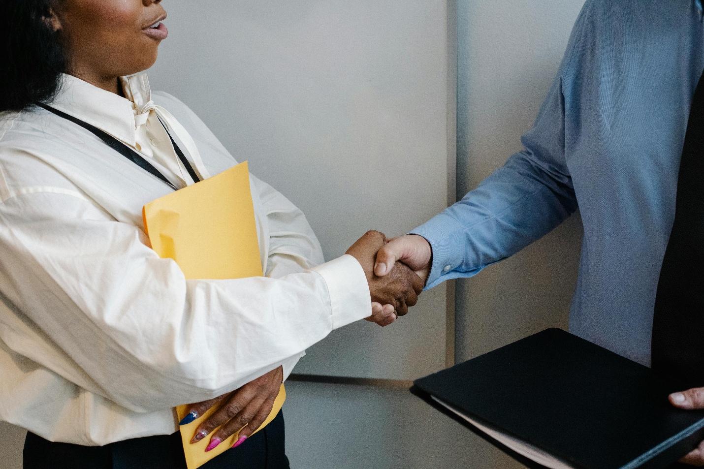 An auto tag agent shaking hands with a client