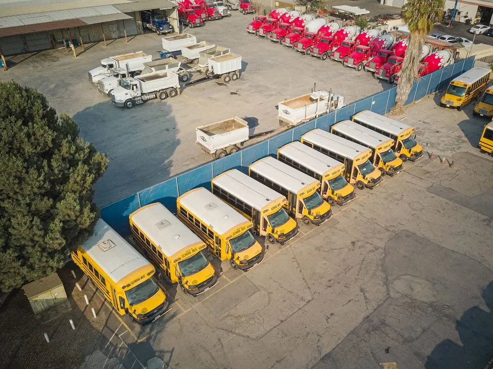 Buses and trucks in a parking lot