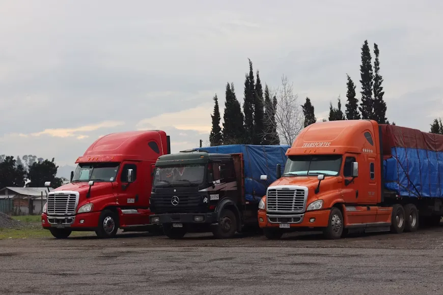 Three trucks in a parking lot
